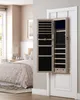 A bedroom scene with a jewelry cabinet hanging on a door. Produktbild-Vorschau