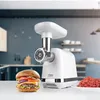 A white meat grinder is displayed on a white surface in a kitchen setting, with a hamburger and ground meat nearby. Anteprima dell’immagine prodotto