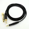 A black audio cable with gold and black connectors is laid out on a white background. Produktbild-Vorschau