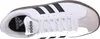 Top-down view of a white Adidas sneaker with black stripes. Anteprima dell’immagine prodotto
