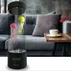 A jellyfish lamp sits on a table next to a couch, with a cup of coffee on the table. Anteprima dell’immagine prodotto