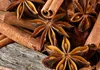 A close-up view of star anise and cinnamon sticks on a wooden surface. Podgląd zdjęcia produktu