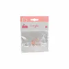 A clear plastic bag containing two small orange pacifiers, with a pink and white cardboard header. Produktbild-Vorschau