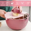 A person is using a multi-functional kitchen grater and colander set. Produktbild-Vorschau