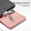 A close-up view of a pink tablet case with a phone, charger, and keys placed on it, partially covered by a gray fabric pouch. Produktbild-Vorschau
