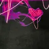 Abstract swirls of pink and purple light against a black background. Produktbild-Vorschau