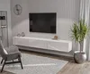 A modern living room with a wall-mounted TV and entertainment unit. Produktbild-Vorschau