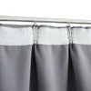 A close-up view of gray curtains hanging from a white curtain rod. Produktbild-Vorschau