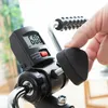 A close-up shot of a person's hand adjusting a knob on a digital display of a pedal exerciser. Produktbild-Vorschau