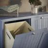 A close-up view of a grey laundry cabinet with a laundry basket inside and towels stacked on top. Produktbild-Vorschau