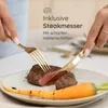 A person is cutting a steak with a gold knife and fork, with a carrot on the plate. Produktbild-Vorschau