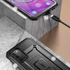 A close-up shot of a black smartphone case, showing its rugged design and a charging cable plugged into the phone. Náhled obrázku produktu