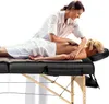 A person is giving a massage to another person on a massage table. Náhled obrázku produktu