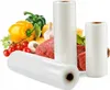 Rolls of vacuum sealing bags are displayed in front of a selection of fresh food items including vegetables, meat, and garlic. Podgląd zdjęcia produktu