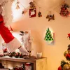 A festive Christmas scene with Santa Claus reaching for cookies next to a ceramic Christmas tree night light. Náhľad obrázku produktu