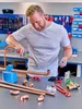 A man is soldering copper pipes in a workshop setting. Produktbild-Vorschau