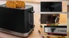 A collage of images showing a black Bosch toaster with stainless steel accents, including close-ups of its controls and base. Voir les images du produit