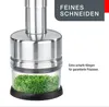 A close-up of a herb chopper with chopped herbs inside. Anteprima dell’immagine prodotto