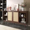A dark wood sideboard with rattan doors, decorated with various items, in a room setting. Voir les images du produit