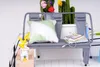 A miniature dollhouse scene with a bench, pillows, plants, and books. Anteprima dell’immagine prodotto
