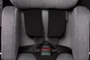 Close-up of a gray car seat with black seatbelts and padding. Produktbild-Vorschau
