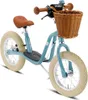 A blue balance bike with a brown seat and handlebars, and a wicker basket on the front, is shown against a white background. Voir les images du produit