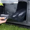 A hand is inserting a black mulching insert into the open compartment of a lawnmower. Produktbild-Vorschau