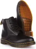 A pair of black leather Dr. Martens boots shown from the side and slightly from the front, with the sole of one boot prominently displayed. Voir les images du produit