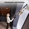 A woman is using a cordless vacuum cleaner to clean blinds. Produktbild-Vorschau