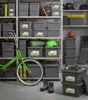 Storage boxes are neatly stacked on shelves in a garage or storage room, with a bicycle and other items present. Anteprima dell’immagine prodotto