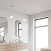 A modern bathroom with two sinks, mirrors, and pendant lights. Náhľad obrázku produktu
