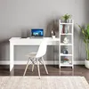 A white desk and a white ladder shelf are set up against a gray wall, with a chair in front of the desk. The desk has a laptop, calculator, and a cup on it. The shelf has books and decorative items. Voir les images du produit