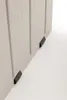 A close-up view of the bottom corner of a light gray storage box, showing two black plastic feet. Produktbild-Vorschau