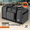 A large gray duffel bag is shown in a studio setting with a blurred background of what appears to be an airport or train station. Produktbild-Vorschau