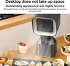 A desktop heater shown next to food items on a table. Produktbild-Vorschau