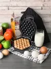 A waffle maker with a freshly made waffle and ingredients for waffles. Náhľad obrázku produktu