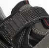 A close-up view of a black and gray sandal, focusing on the strap and stitching. Produktbild-Vorschau