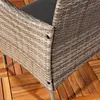Close-up of the corner of a gray polyrattan bench with a dark gray seat cushion, resting on a wooden deck. Produktbild-Vorschau