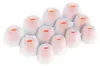 A collection of white silicone ear tips with orange inner cores, arranged in a staggered pattern on a white background. Produktbild-Vorschau