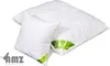 Two white pillows with green trim and a green label are shown against a white background. Produktbild-Vorschau