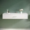 A white floating shelf with a drawer is mounted on a green wall. Decorative items like a diffuser, a chess piece, two small bottles, and a vase with flowers are placed on the shelf. Anteprima dell’immagine prodotto
