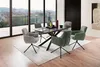 A dining set with a dark table and olive and gray chairs, set in a modern dining room with a large window overlooking a city view. Produktbild-Vorschau