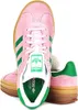 A pair of pink Adidas Gazelle Bold W sneakers with green accents and a gum sole, shown from a slightly angled front view against a white background. Produktbild-Vorschau