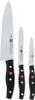 Three kitchen knives of varying sizes are displayed vertically against a white background. Náhled obrázku produktu