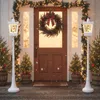 A festive Christmas scene at a doorway with decorated trees and lampposts. Produktbild-Vorschau