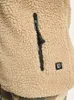 Close-up of a beige fleece jacket with a black zipper and a small black logo patch. Produktbild-Vorschau