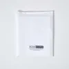A white duvet cover is laid flat against a white background, showing the brand logo and website at the bottom. Produktbild-Vorschau