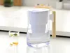 A water filter pitcher and a glass of infused water on a kitchen counter. Produktbild-Vorschau