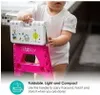 A child holding a pink foldable stool with a white top decorated with cartoon animals. Náhled obrázku produktu