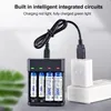 A battery charger with AA and AAA batteries plugged into a USB adapter. Podgląd zdjęcia produktu